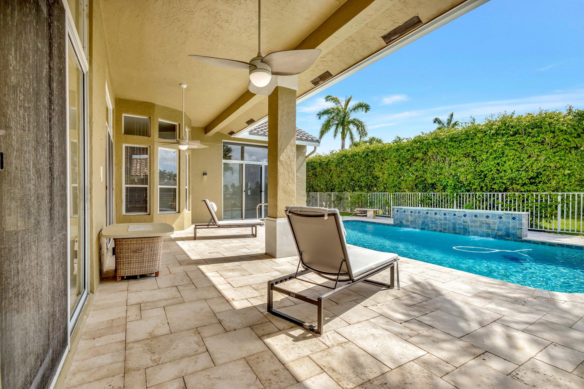 19236 Bay Leaf Court Boca Raton, FL 33498 - Photo 61 of 100 a view of a patio with a dining table and chairs with wooden fence