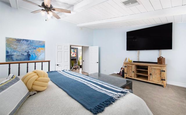 a bedroom with furniture and a flat screen tv