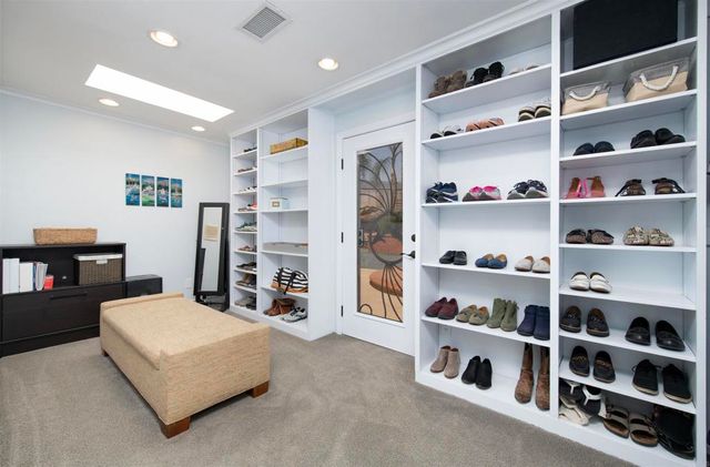 a bedroom with a bed a chair and a window