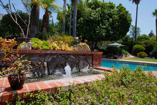 swimming pool with outdoor seating and yard