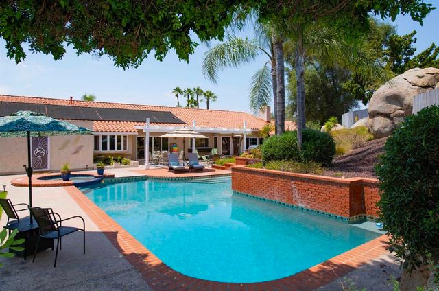 a view of a swimming pool with a table and chairs