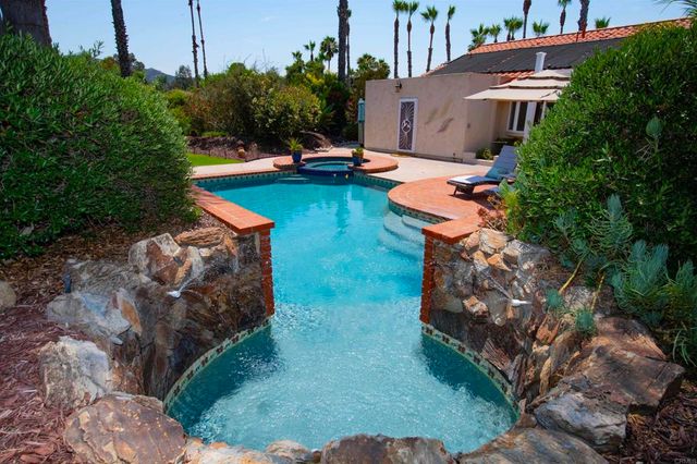 an aerial view of a house with swimming pool garden and patio