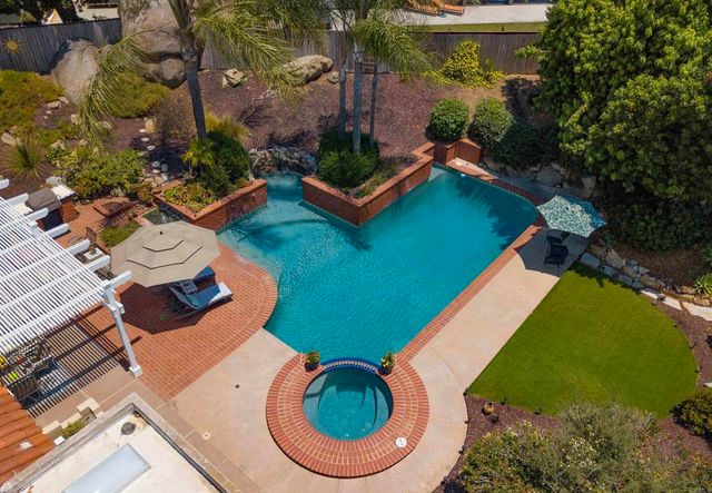 an aerial view of a house with a yard and outdoor seating