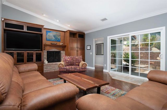 a living room with furniture tv and a fireplace