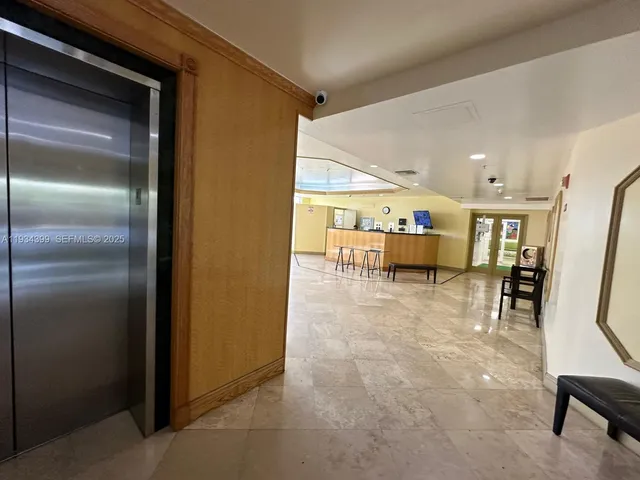 a dining room with furniture and a kitchen view
