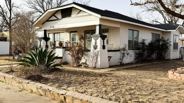 a view of a house with yard and sitting area