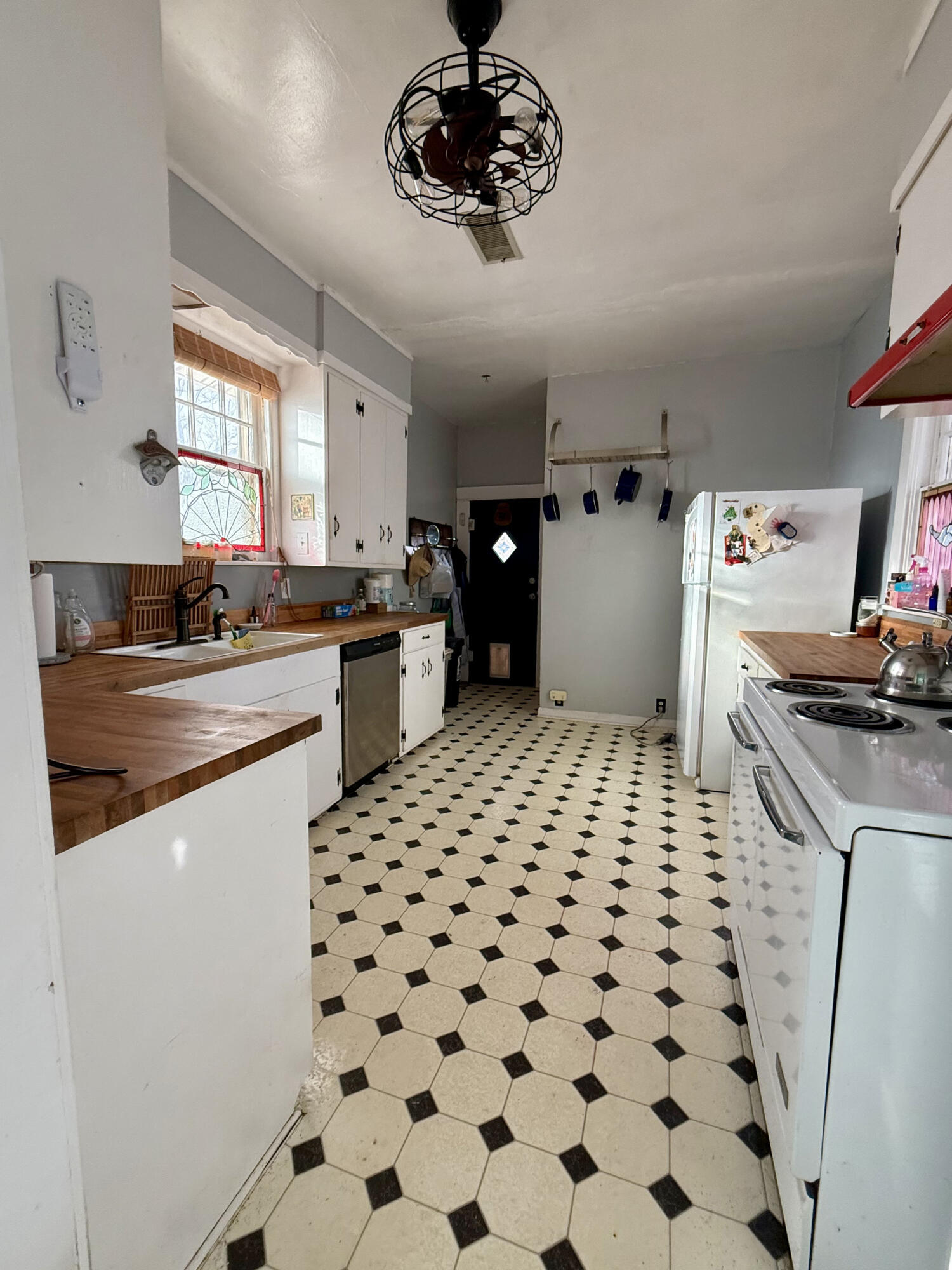 302 West 10th Street Post, TX 79356 - Photo 13 of 30 a kitchen with a sink and refrigerator
