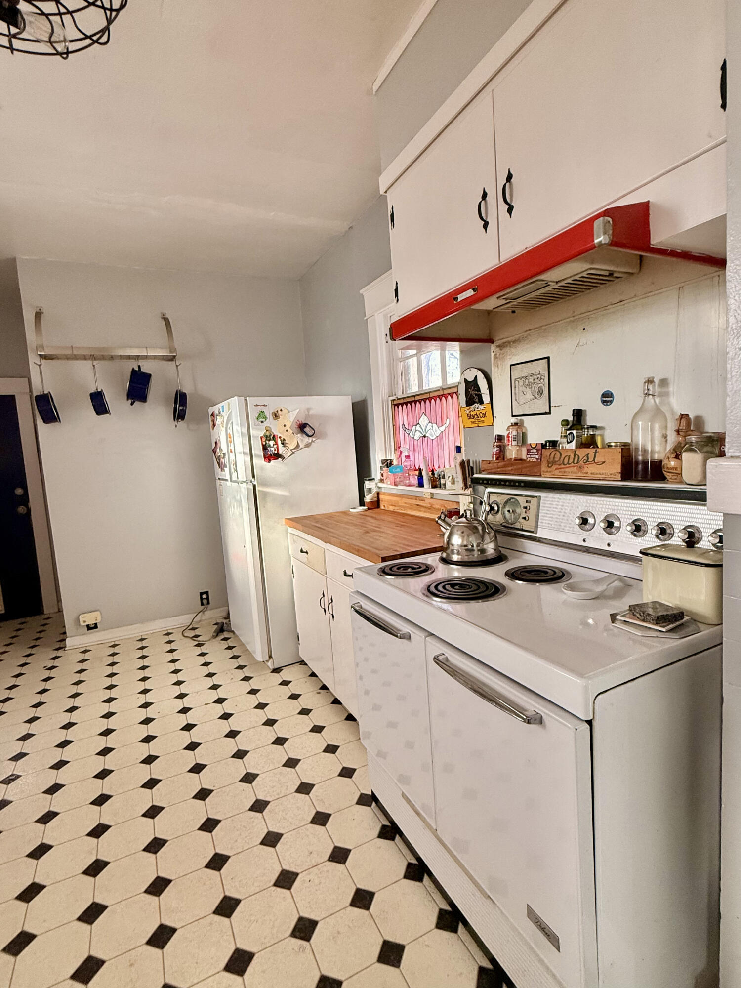302 West 10th Street Post, TX 79356 - Photo 14 of 30 a kitchen with stainless steel appliances a stove a sink and a refrigerator