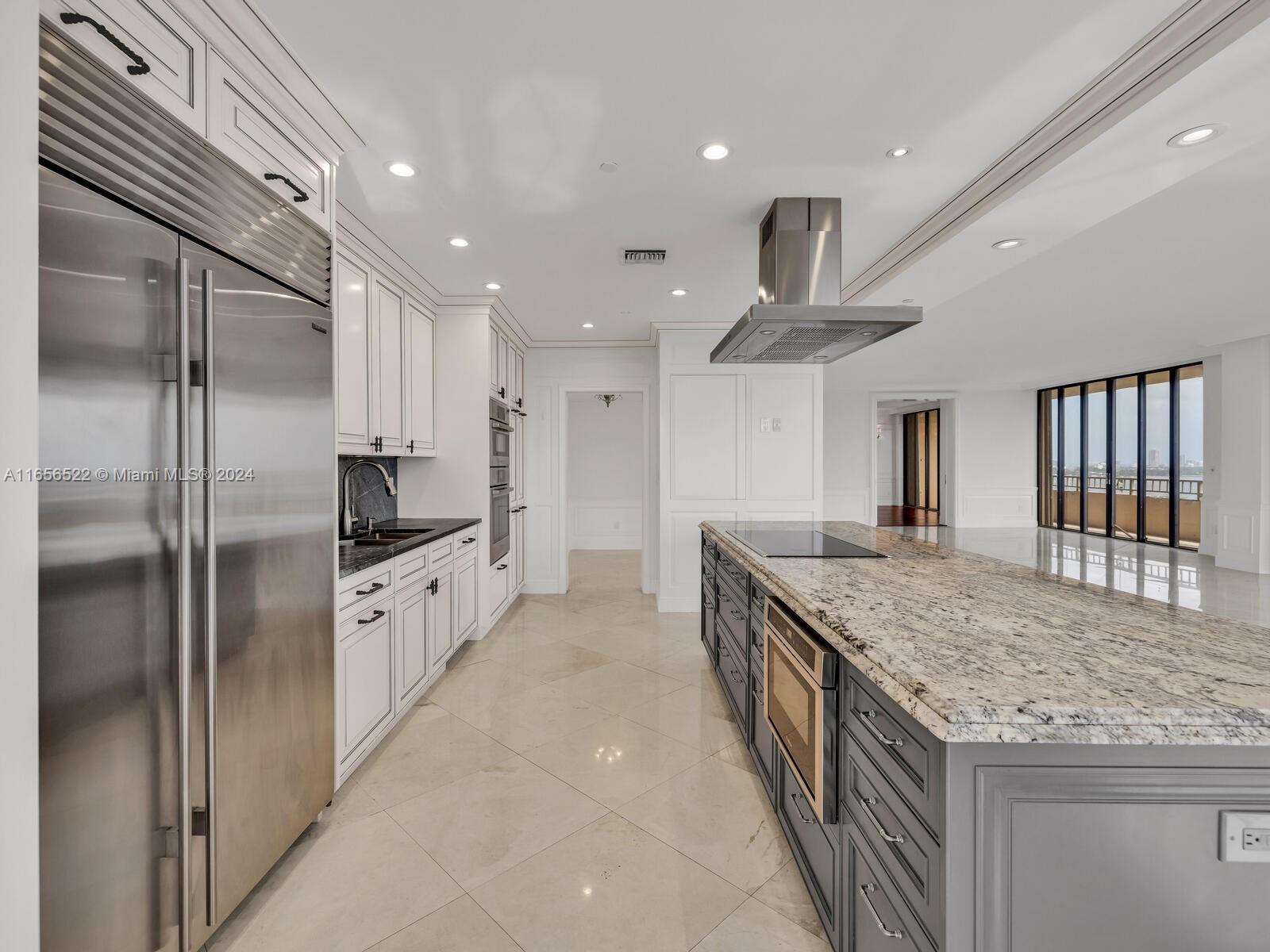 11113 Biscayne Boulevard, Unit PH5 Miami, FL 33181 - Photo 14 of 58 a kitchen with stainless steel appliances granite countertop a refrigerator and a sink