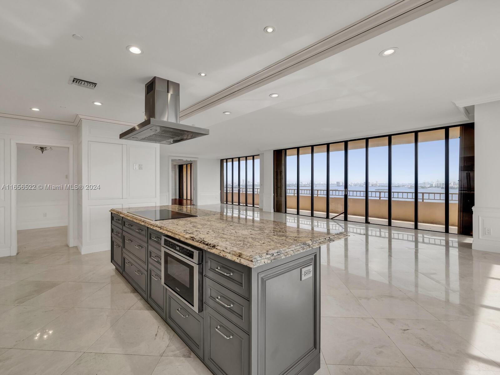 11113 Biscayne Boulevard, Unit PH5 Miami, FL 33181 - Photo 15 of 58 a kitchen with stainless steel appliances granite countertop a stove and a large refrigerator