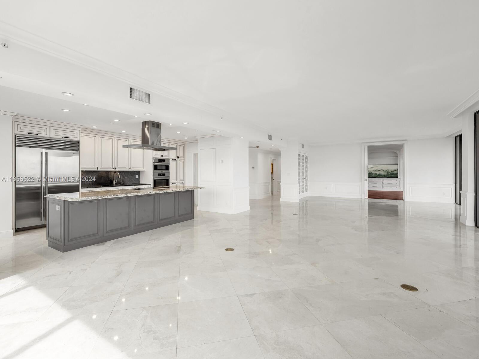 11113 Biscayne Boulevard, Unit PH5 Miami, FL 33181 - Photo 17 of 58 a large kitchen with cabinets and stainless steel appliances