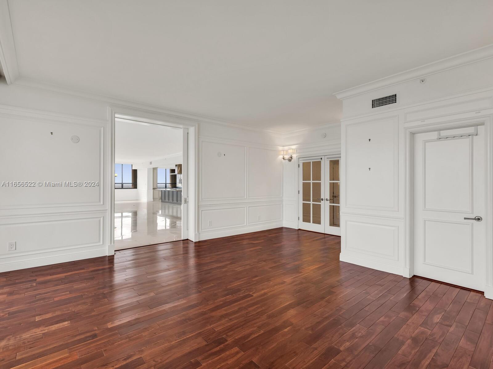 11113 Biscayne Boulevard, Unit PH5 Miami, FL 33181 - Photo 23 of 58 a view of empty room with wooden floor