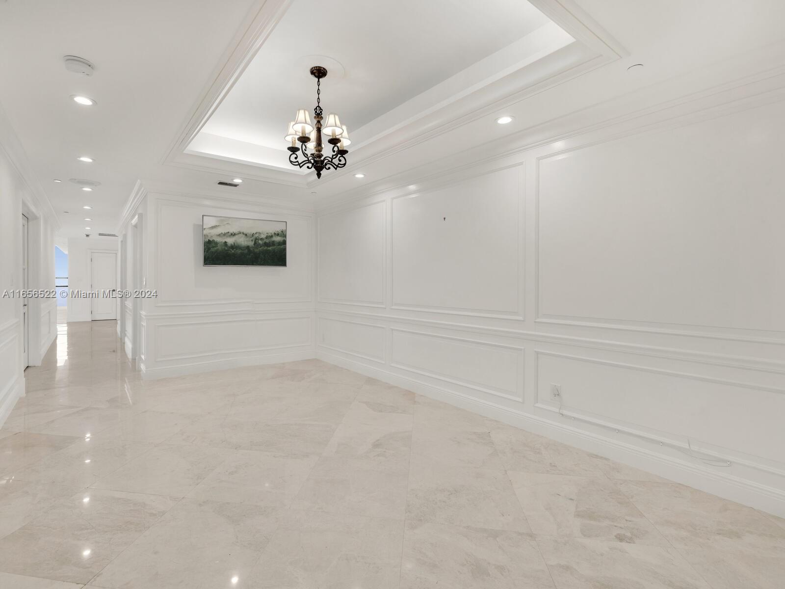 11113 Biscayne Boulevard, Unit PH5 Miami, FL 33181 - Photo 27 of 58 a view of a livingroom with a ceiling fan window and a chandelier