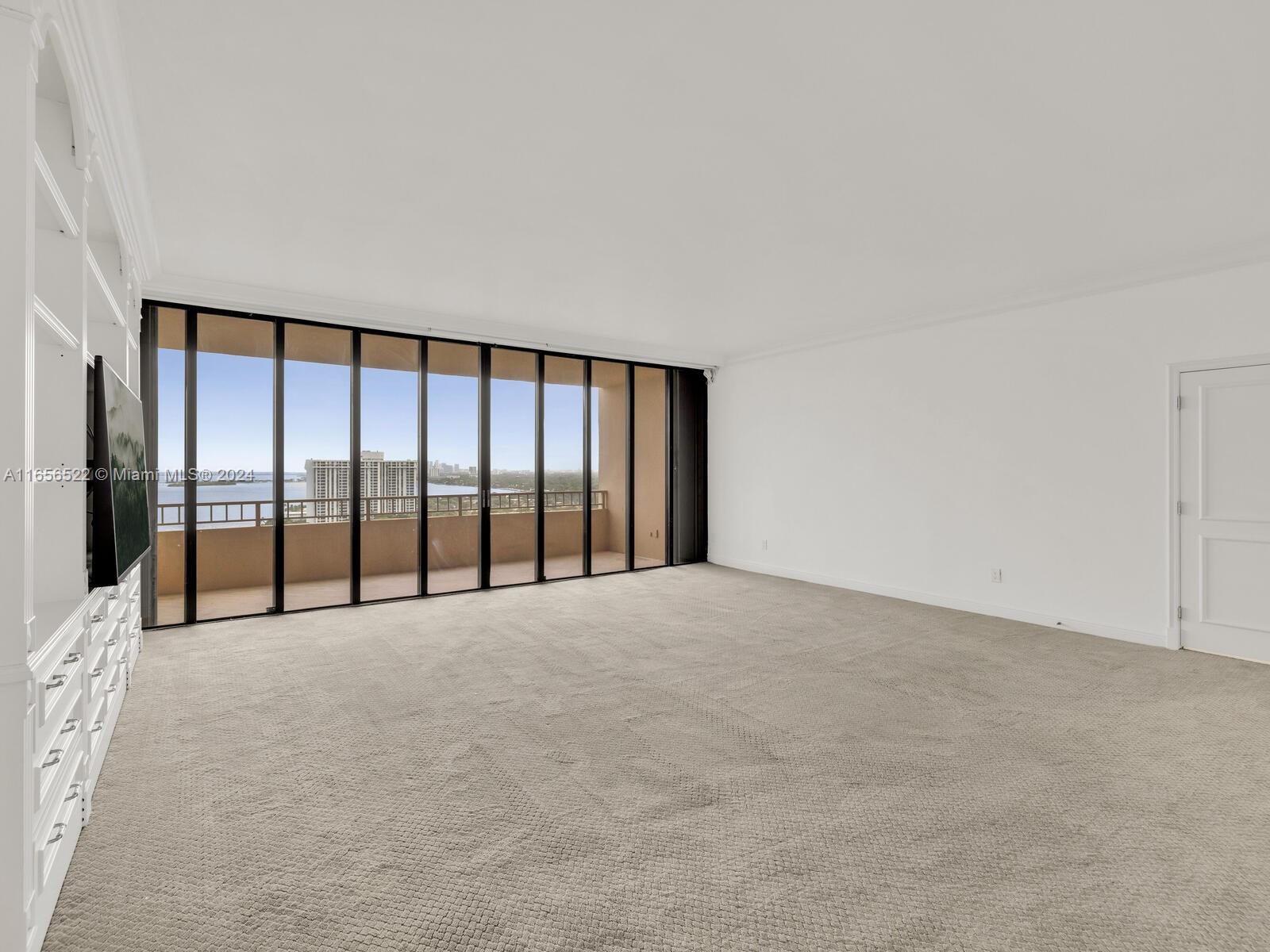 11113 Biscayne Boulevard, Unit PH5 Miami, FL 33181 - Photo 29 of 58 a view of an empty room with a window