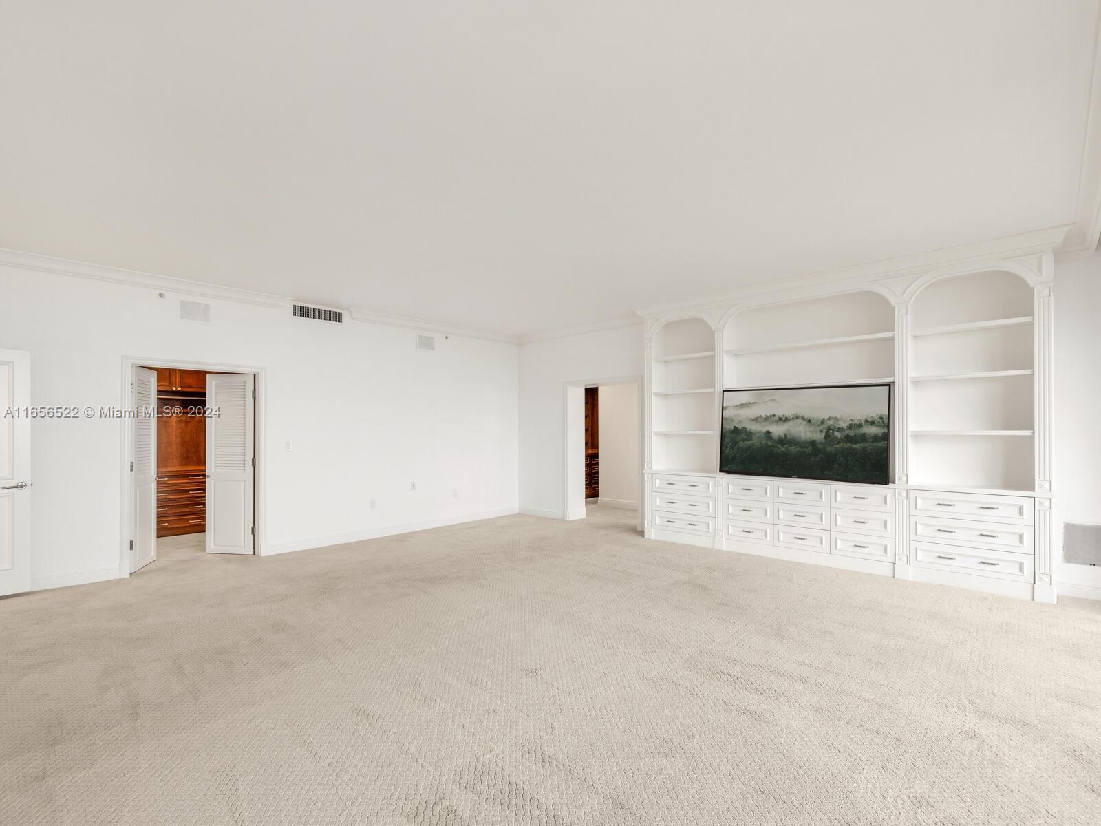 11113 Biscayne Boulevard, Unit PH5 Miami, FL 33181 - Photo 30 of 58 a view of an empty room with a fireplace