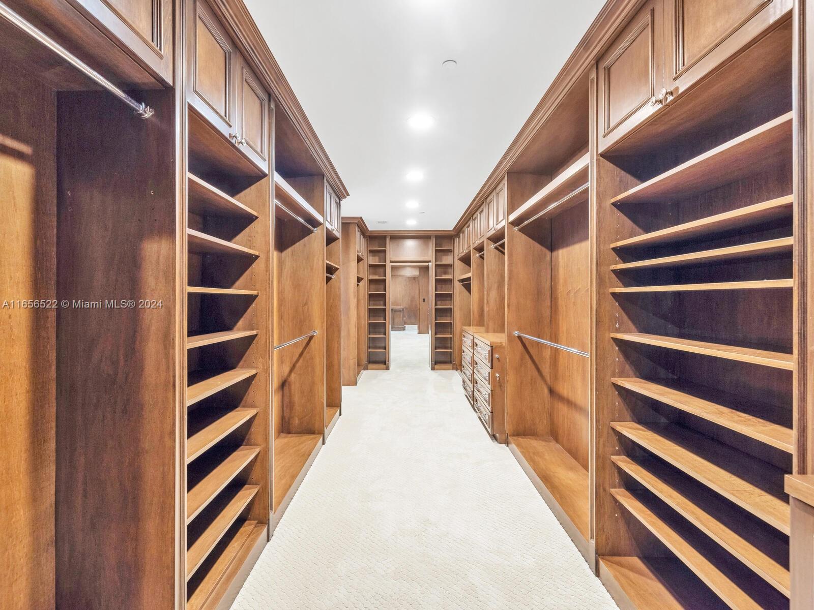 11113 Biscayne Boulevard, Unit PH5 Miami, FL 33181 - Photo 32 of 58 a view of walk in closet with empty racks