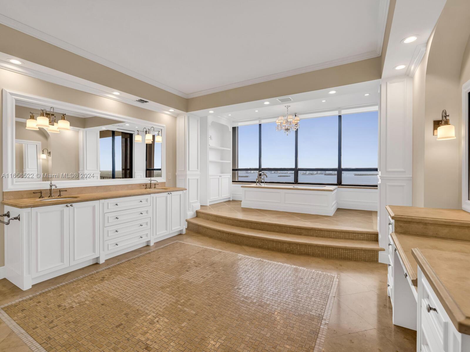 11113 Biscayne Boulevard, Unit PH5 Miami, FL 33181 - Photo 34 of 58 a spacious en suite bathroom with a double vanity sink and a large mirror