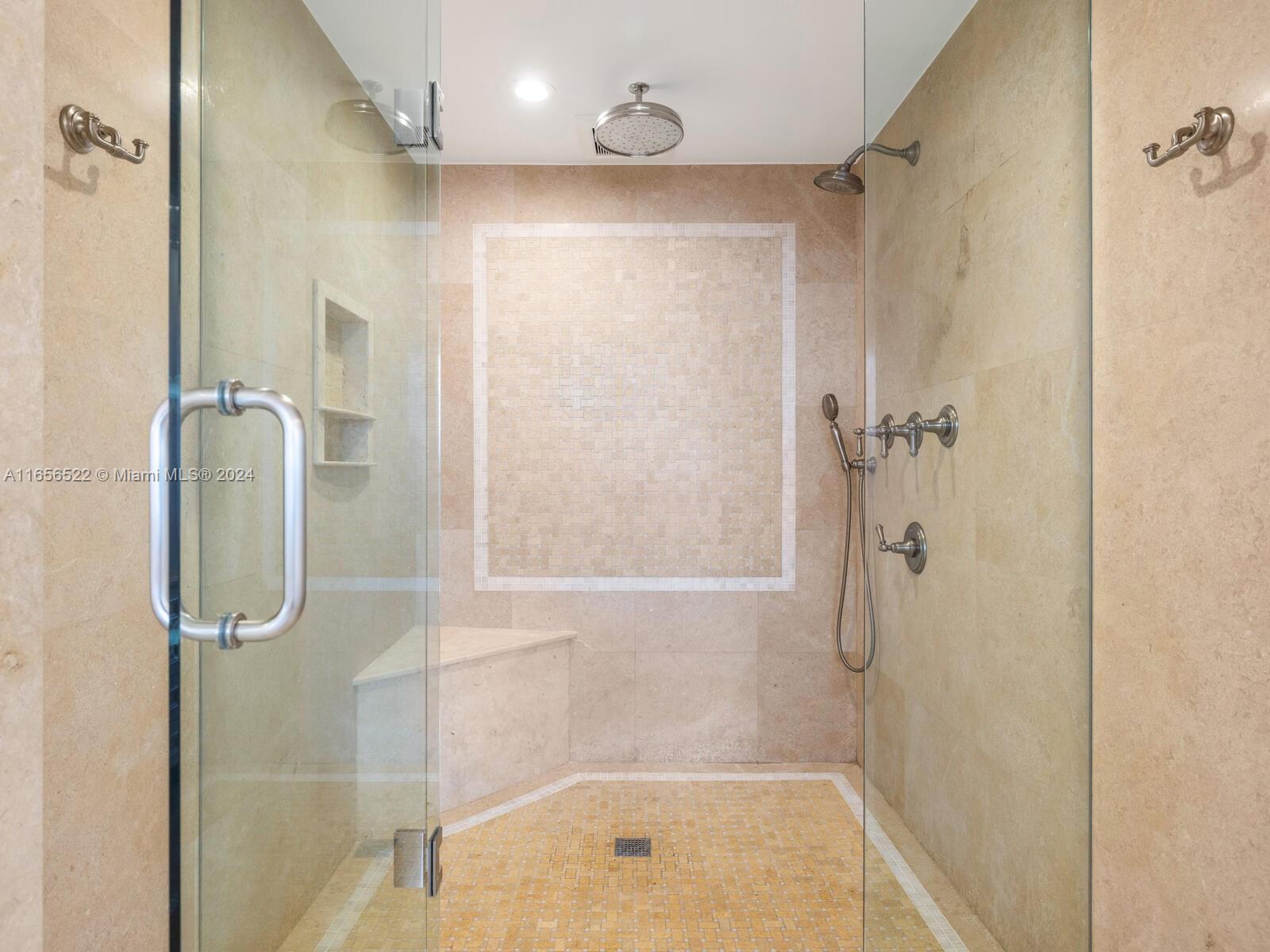 11113 Biscayne Boulevard, Unit PH5 Miami, FL 33181 - Photo 35 of 58 a bathroom with a shower and a bath tub