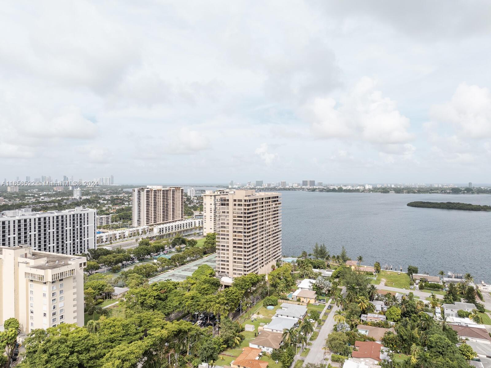 11113 Biscayne Boulevard, Unit PH5 Miami, FL 33181 - Photo 40 of 58 a view of a balcony with wooden floor and lake view