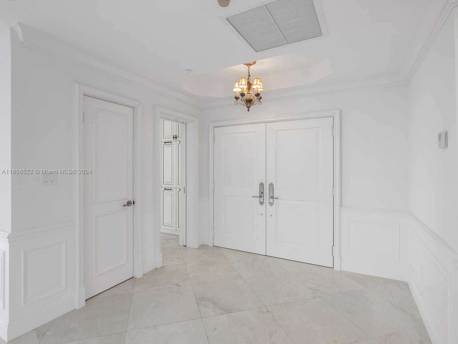 11113 Biscayne Boulevard, Unit PH5 Miami, FL 33181 - Photo 4 of 58 a view of an empty room with a chandelier fan