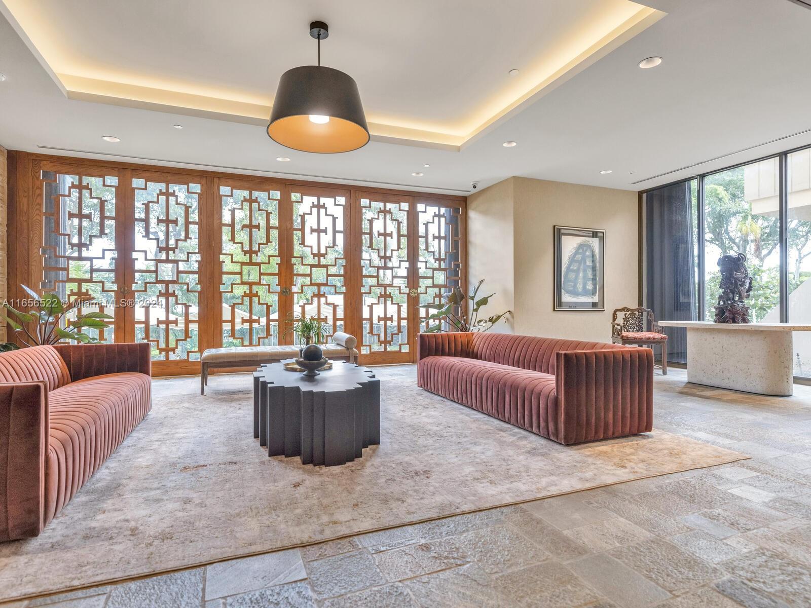 11113 Biscayne Boulevard, Unit PH5 Miami, FL 33181 - Photo 50 of 58 a living room with furniture and large windows