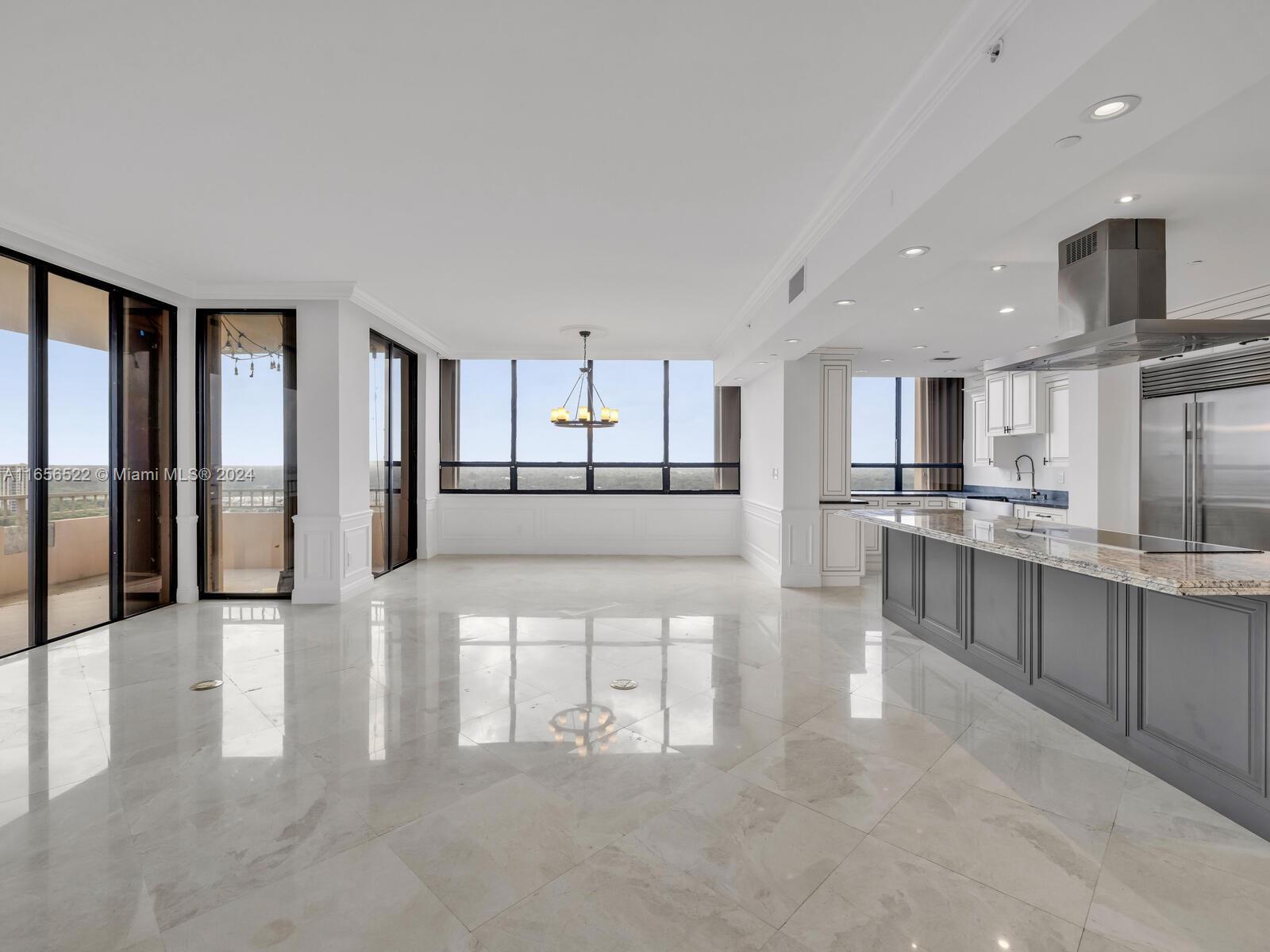 11113 Biscayne Boulevard, Unit PH5 Miami, FL 33181 - Photo 5 of 58 a view of a kitchen with kitchen island a counter top space a sink stainless steel appliances and cabinets