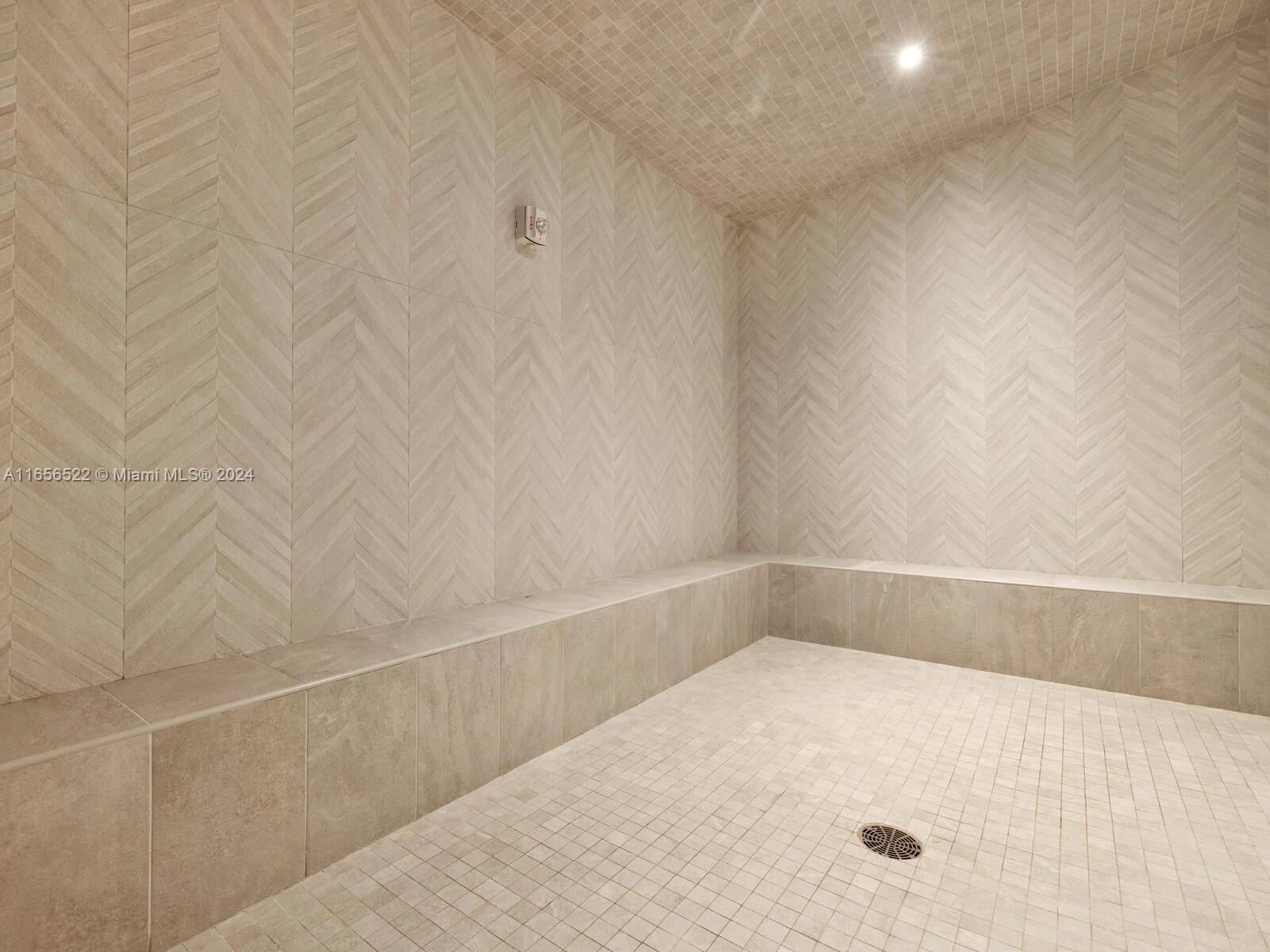 11113 Biscayne Boulevard, Unit PH5 Miami, FL 33181 - Photo 55 of 58 a view of a bathtub in a white bathroom