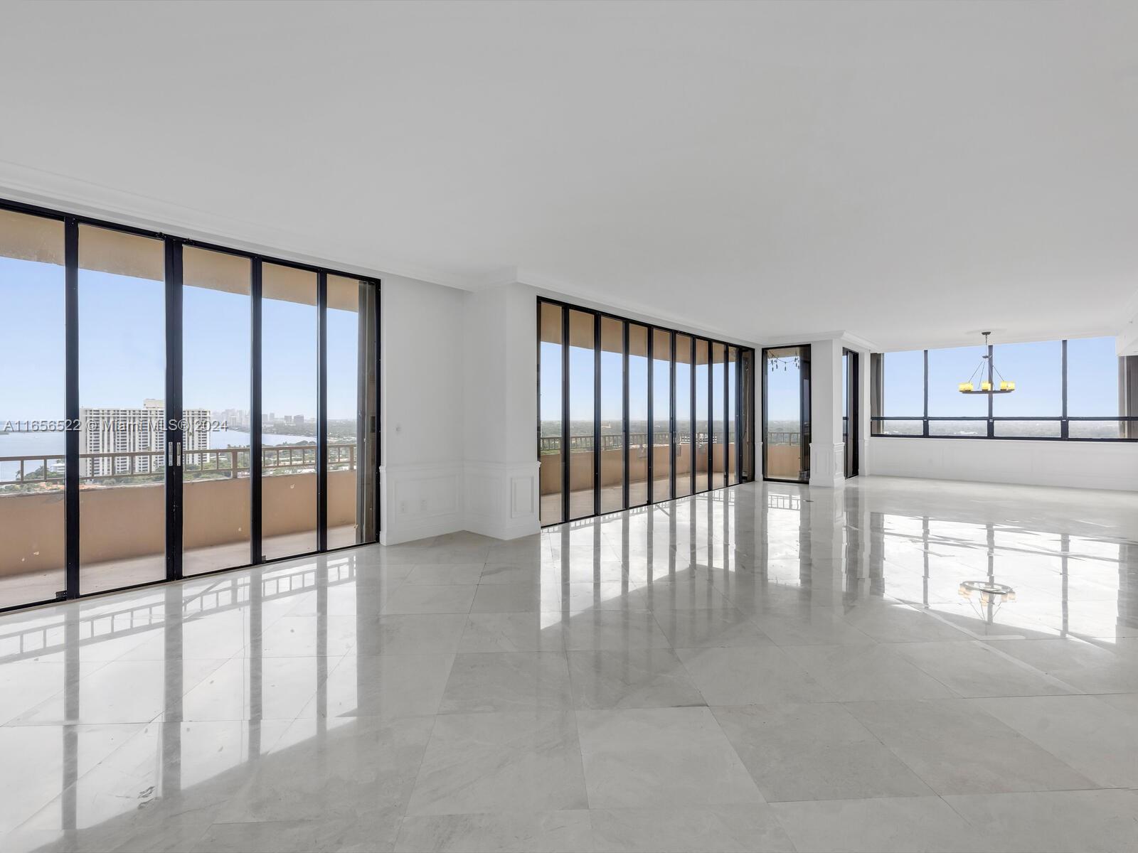 11113 Biscayne Boulevard, Unit PH5 Miami, FL 33181 - Photo 6 of 58 a view of an empty room with a large window