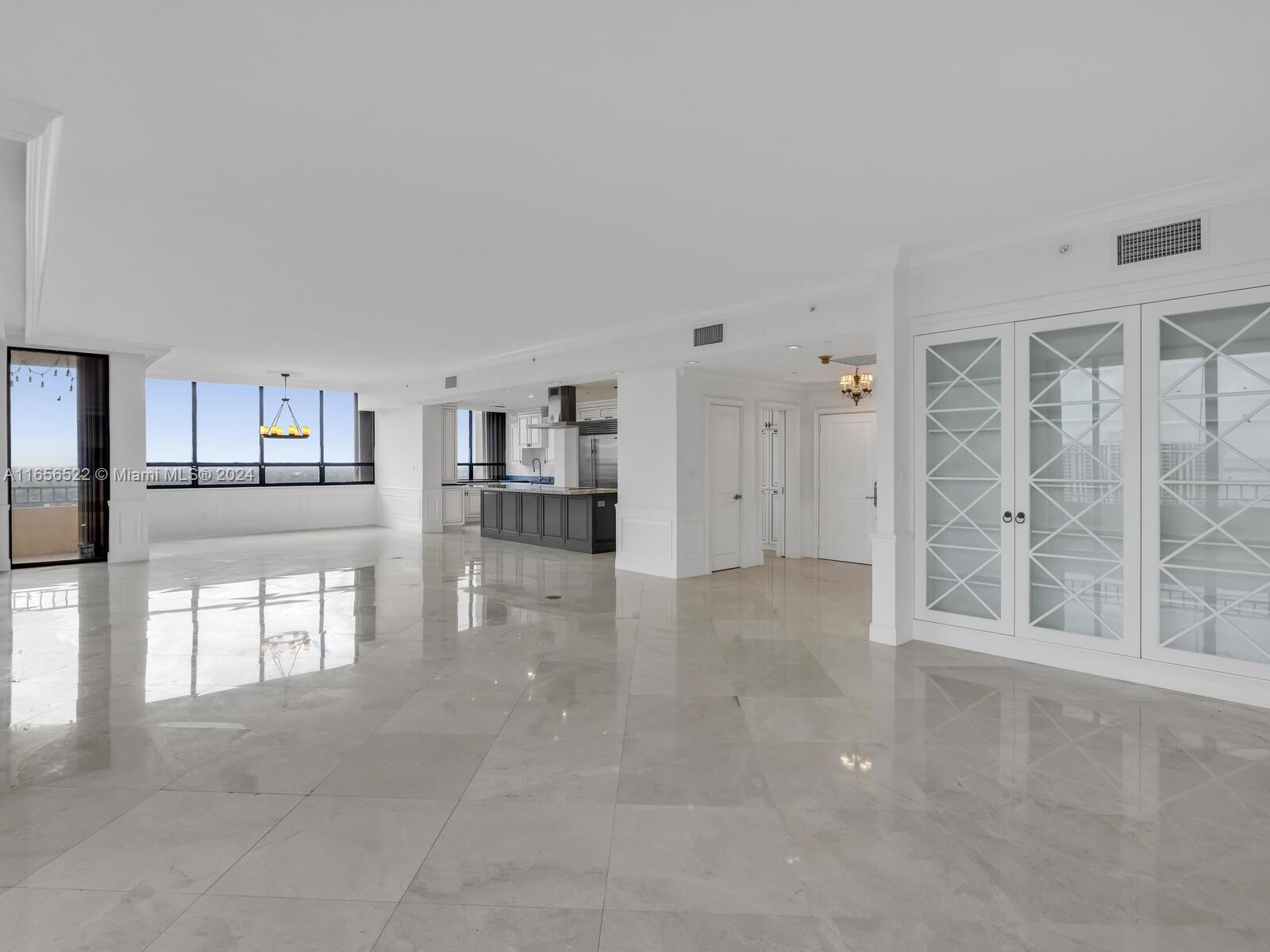 11113 Biscayne Boulevard, Unit PH5 Miami, FL 33181 - Photo 7 of 58 a view of livingroom with an empty space