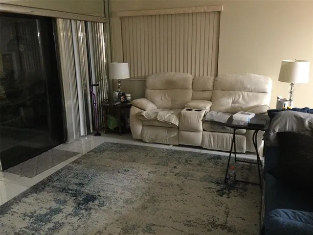 a living room with furniture and a lamp