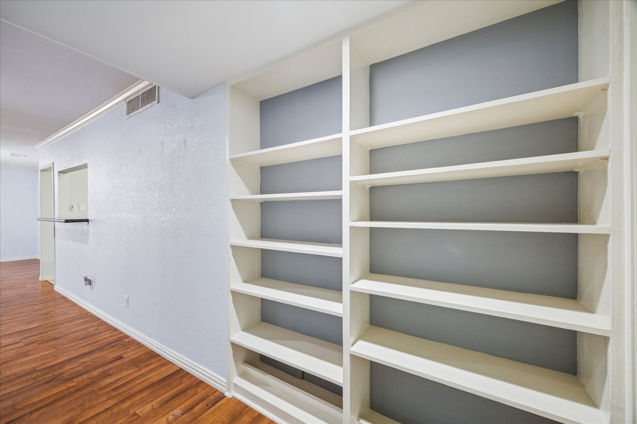 6304 Crab Orchard Road, Unit 6304 Houston, TX 77057 - Photo 12 of 23 Custom built-in shelves provide the perfect space to display books, artwork, or collectibles, combining style and functionality while enhancing the room’s character.