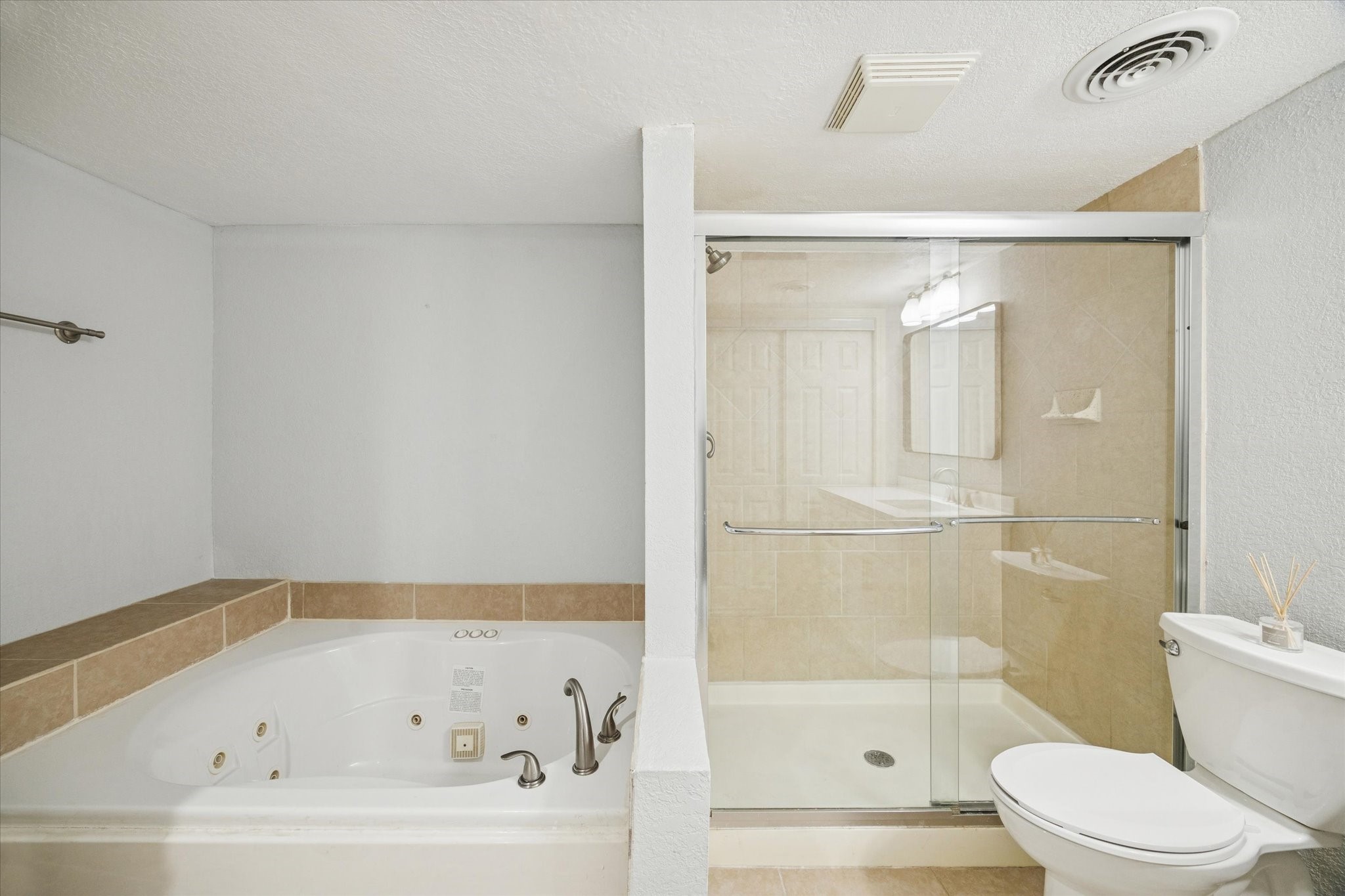 6304 Crab Orchard Road, Unit 6304 Houston, TX 77057 - Photo 16 of 23 Close-up view highlighting the luxurious whirlpool tub and separate glass-enclosed shower.