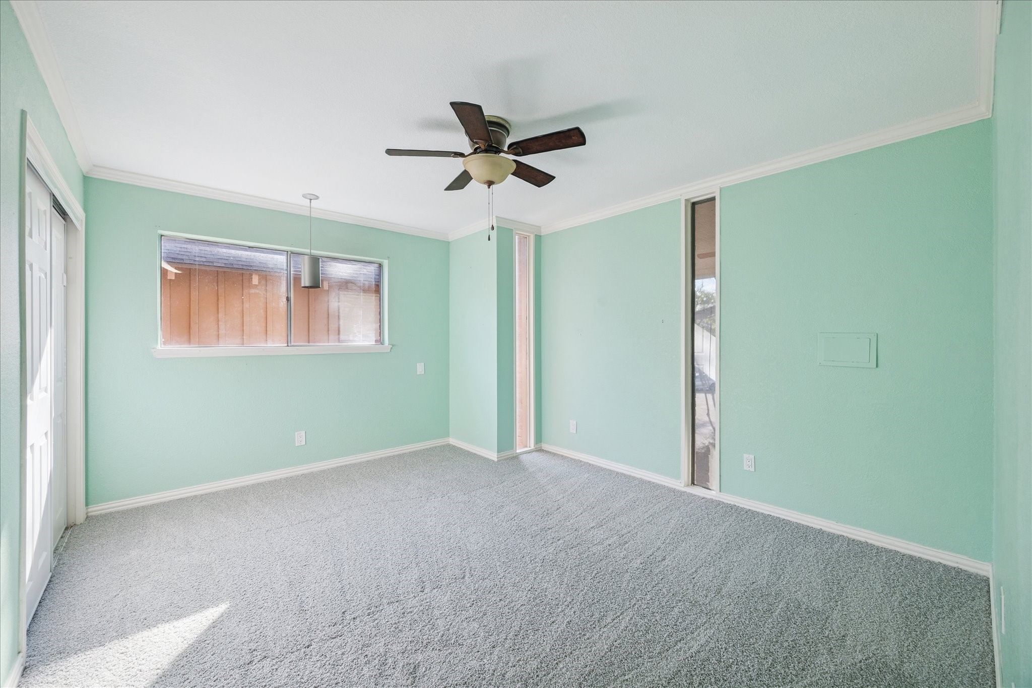 6304 Crab Orchard Road, Unit 6304 Houston, TX 77057 - Photo 17 of 23 Secondary bedroom featuring striking floor-to-ceiling windows, brand-new carpet, and a ceiling fan, creating a bright and airy space.