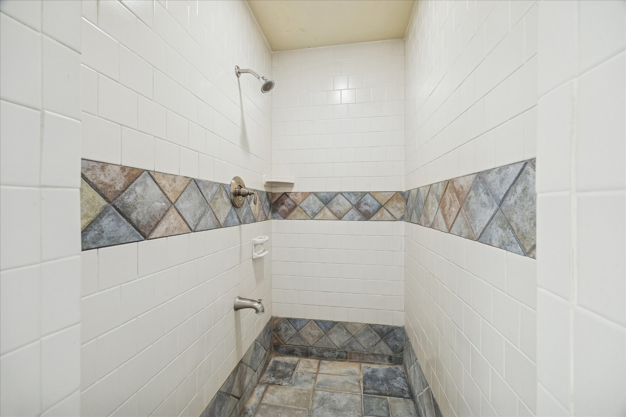 6304 Crab Orchard Road, Unit 6304 Houston, TX 77057 - Photo 20 of 23 Generously sized walk-in shower featuring a classic tile surround for a clean, modern look.