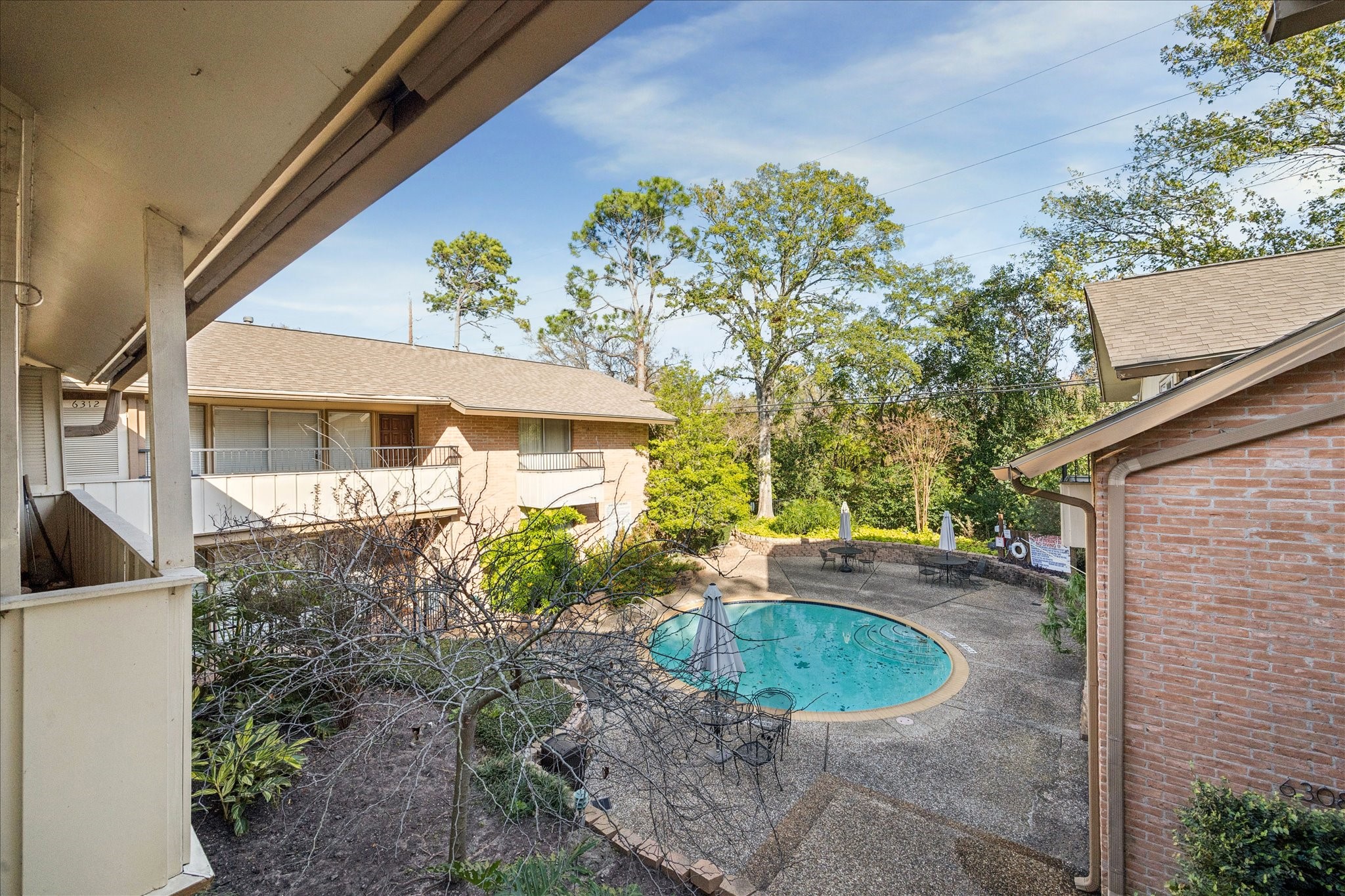 6304 Crab Orchard Road, Unit 6304 Houston, TX 77057 - Photo 22 of 23 Another view of the pool and courtyard form the balcony.