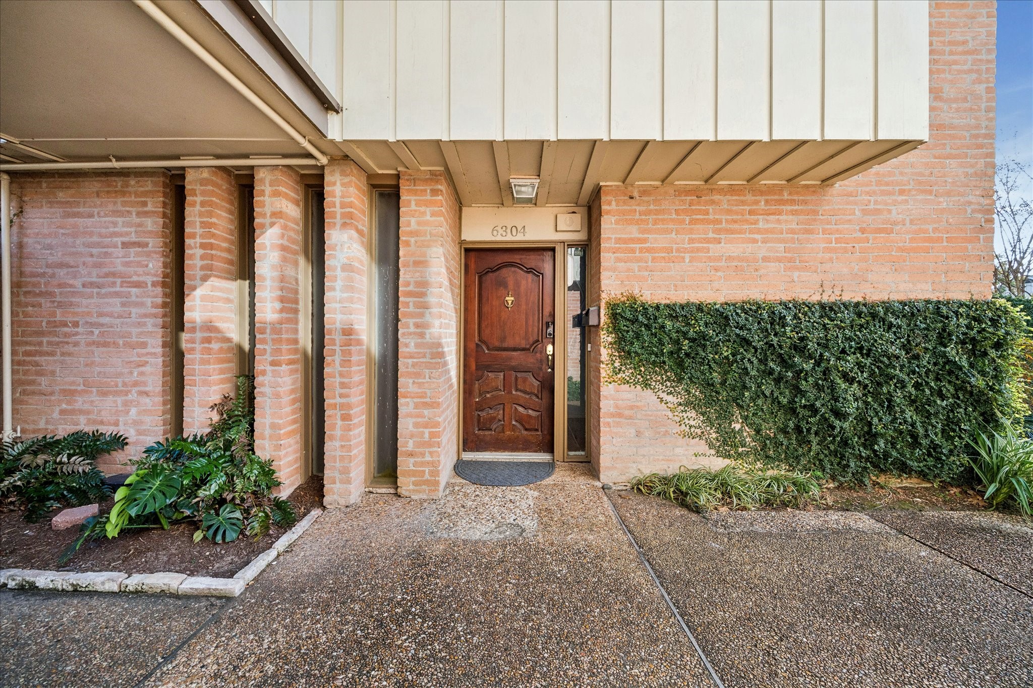 6304 Crab Orchard Road, Unit 6304 Houston, TX 77057 - Photo 3 of 23 Brick-accented first-floor entry offering curb appeal and easy access.