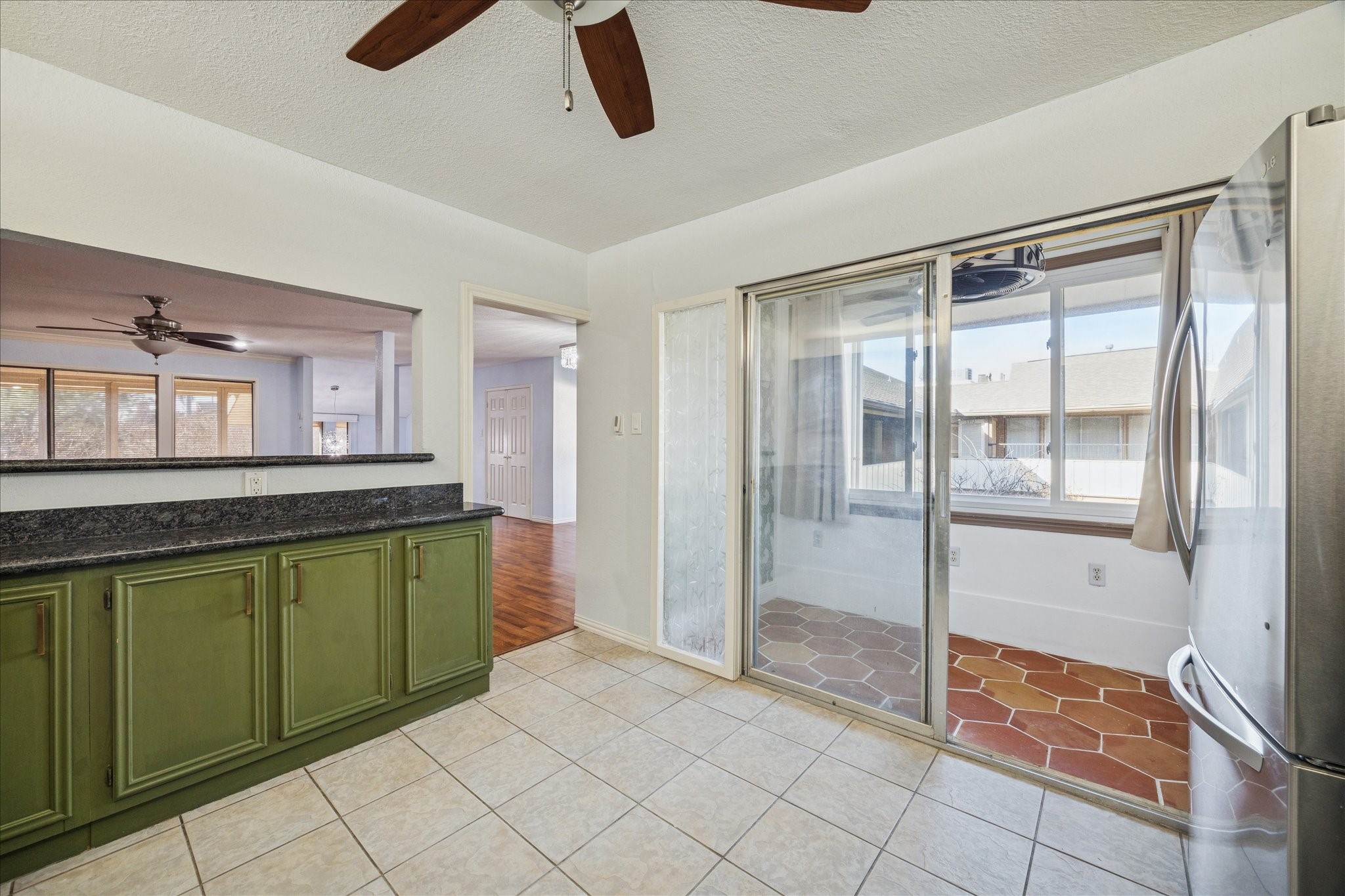 6304 Crab Orchard Road, Unit 6304 Houston, TX 77057 - Photo 7 of 23 A view of the cozy sunroom with classic Saltillo tile, offering peaceful views of the pool and courtyard.