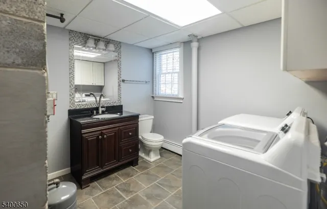 a bathroom with a sink a toilet and mirror