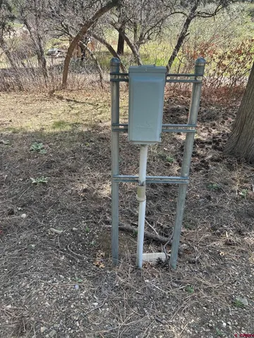 a view of a wooden bench under a large tree