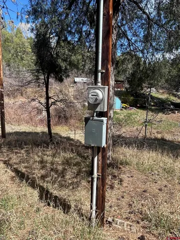 a view of a yard with iron fence