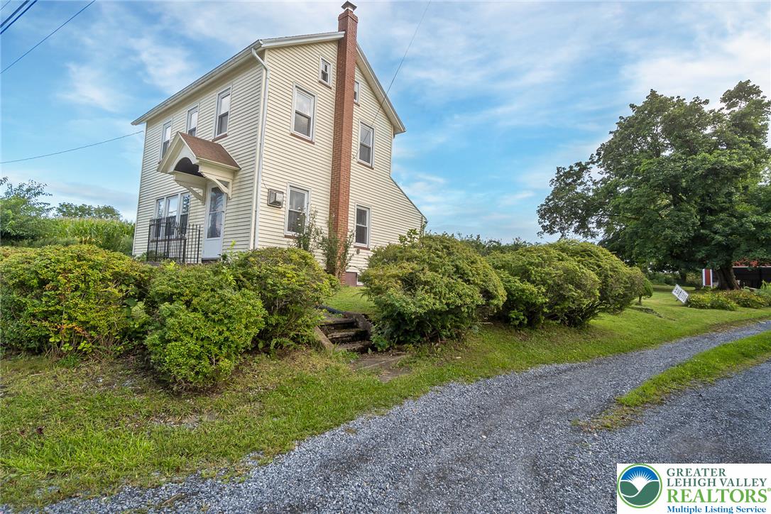 506 Richmond Road Bangor, PA 18013 - Photo 41 of 43 A charming multistory residence sits nestled alongside mature landscaping and a gravel driveway.