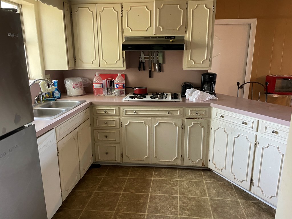 2204 Lange Polk Road Brady, TX 76825 - Photo 24 of 30 a kitchen with white cabinets appliances and a sink