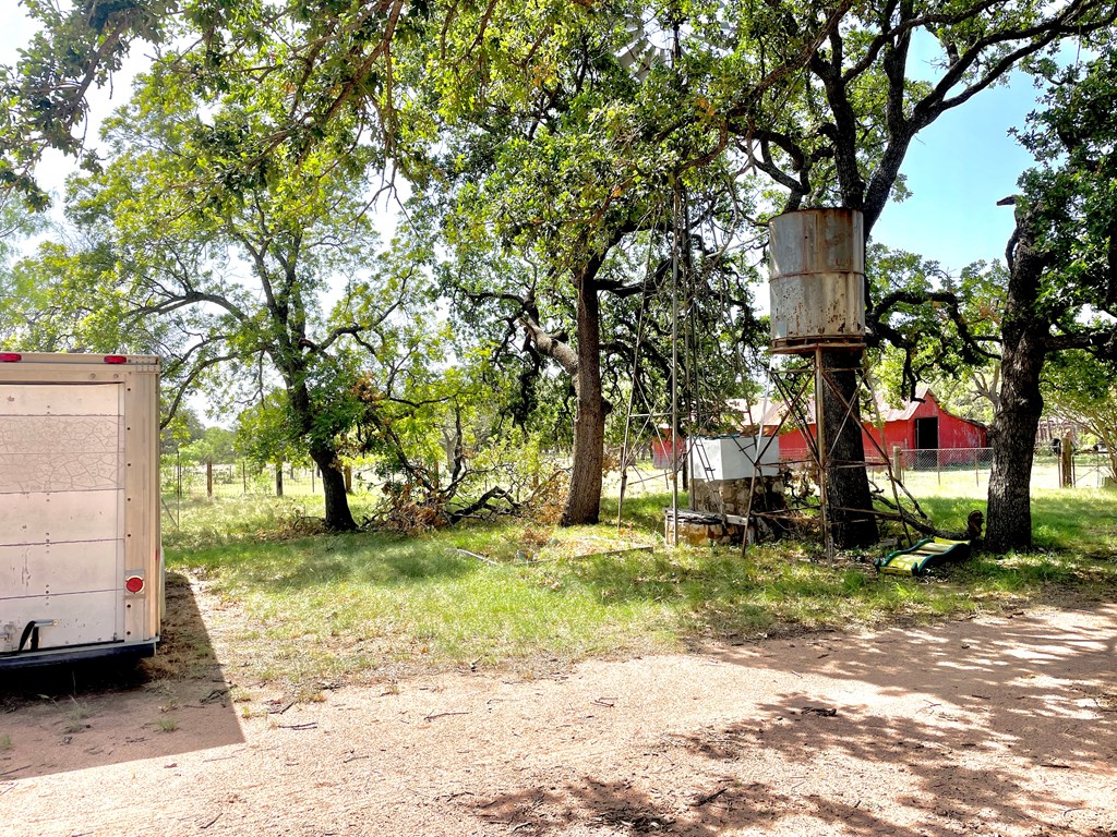 2204 Lange Polk Road Brady, TX 76825 - Photo 30 of 30 a view of a yard with a house and a tree in the background