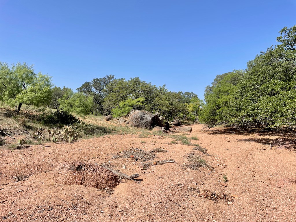 2204 Lange Polk Road Brady, TX 76825 - Photo 7 of 30 a view of a dirt road with a building in the background