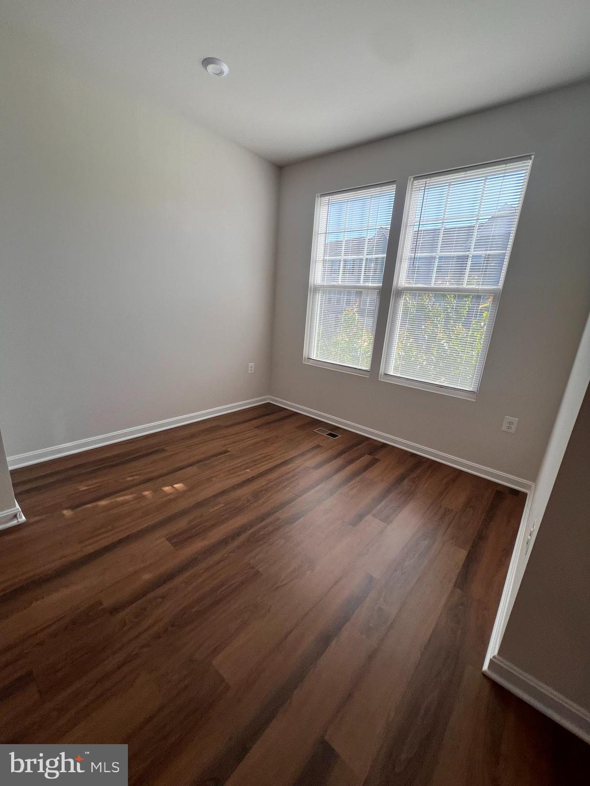 36 Anthem Street Ranson, WV 25438 - Photo 10 of 16 wooden floor in an empty room with a window