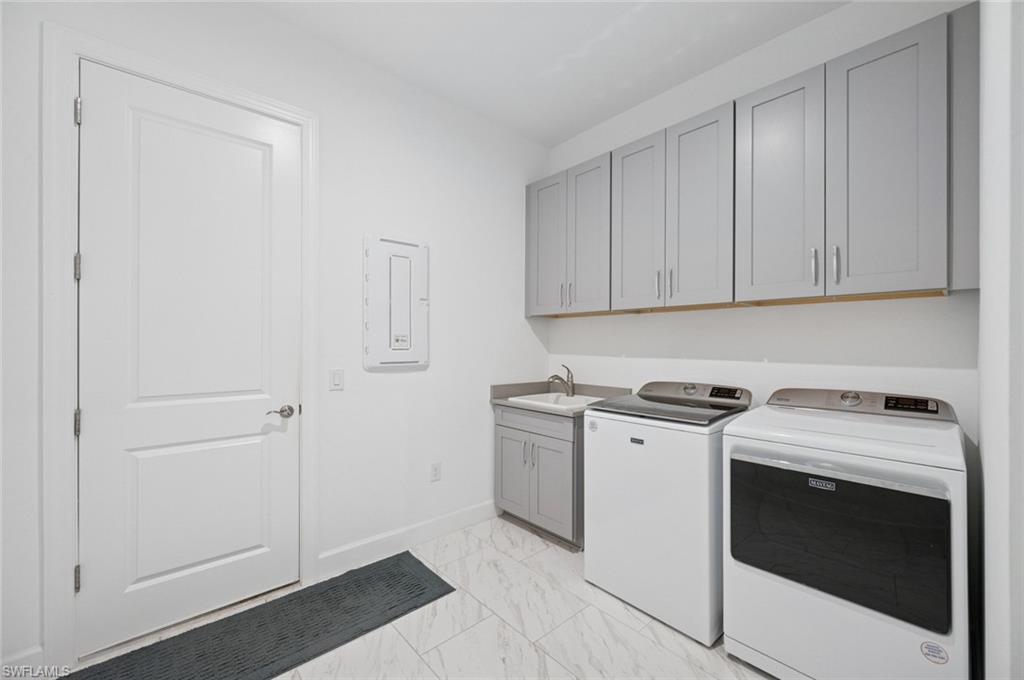 3171 Quilcene Lane Naples, FL 34114 - Photo 27 of 37 a kitchen with a stove and a sink