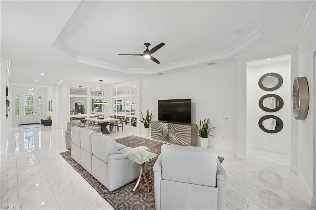 3171 Quilcene Lane Naples, FL 34114 - Photo 8 of 37 a living room with furniture and a flat screen tv