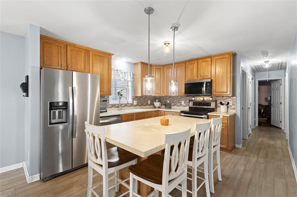 416 Reamer Avenue Carnegie, PA 15106 - Photo 8 of 33 a kitchen with stainless steel appliances a refrigerator a stove microwave and white cabinets
