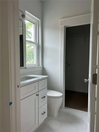 a bathroom with a sink toilet and window