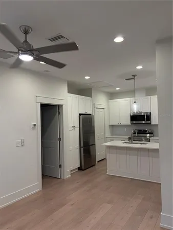 a kitchen with stainless steel appliances granite countertop a refrigerator and a stove top oven